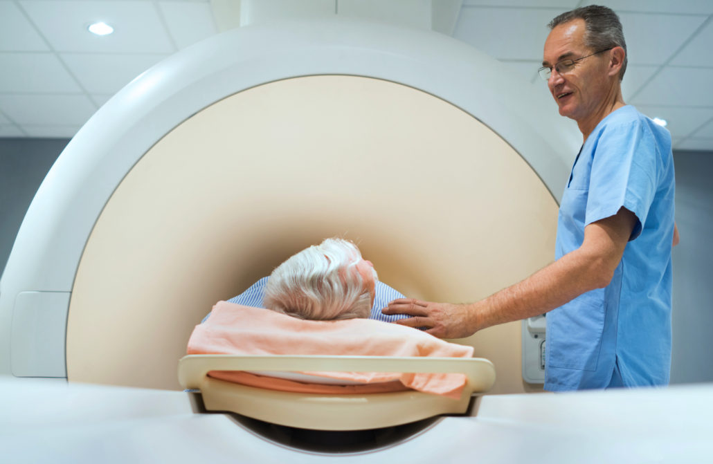 Mature radiologist consoling patient before MRI scan. California