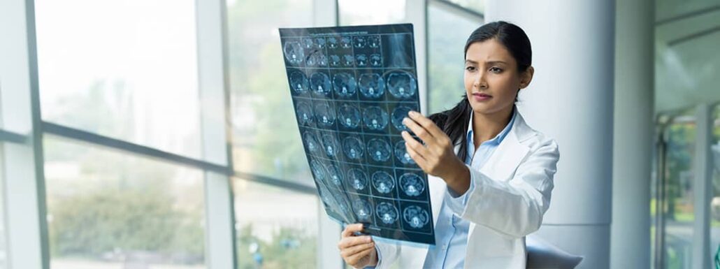 California Imaging and Diagnostics - Female Doctor Inspects Xrays